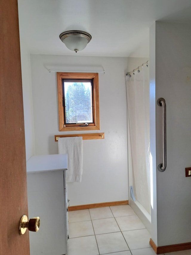 bathroom with vanity, a shower with shower curtain, and tile patterned flooring