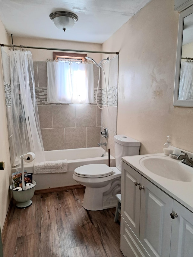 full bathroom featuring vanity, shower / bath combo, hardwood / wood-style flooring, and toilet