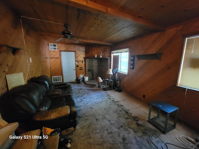 living room with beam ceiling, ceiling fan, wood walls, and wooden ceiling