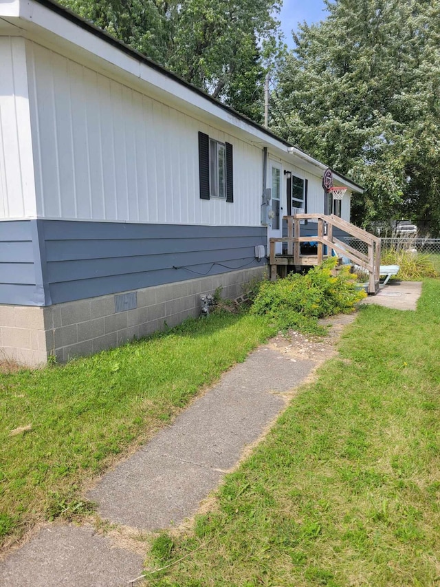 view of front of property featuring a front lawn and a wooden deck