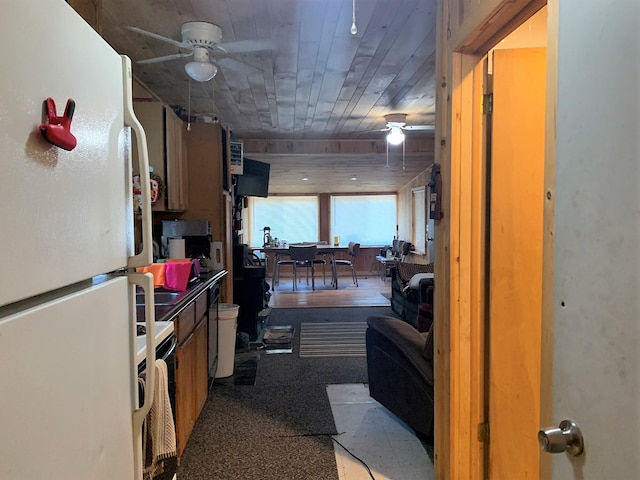 kitchen featuring white refrigerator, carpet, and ceiling fan