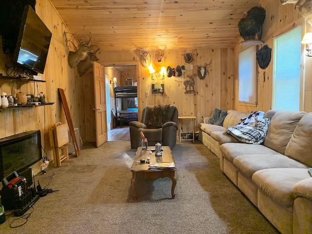 living room with wooden ceiling, wood walls, and carpet flooring