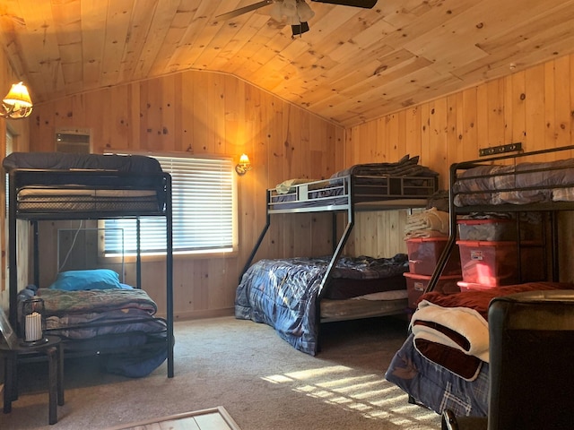 bedroom featuring lofted ceiling, wood walls, ceiling fan, and wooden ceiling