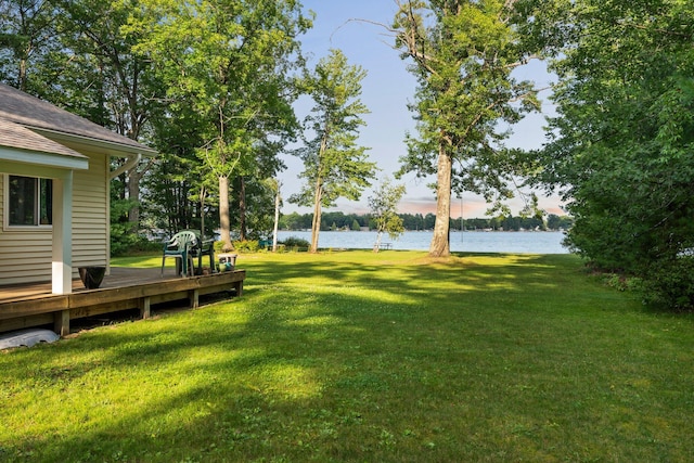 view of yard featuring a deck with water view