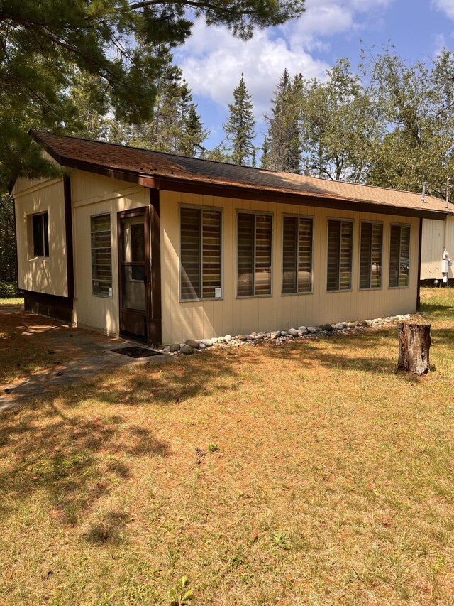 back of house with a yard