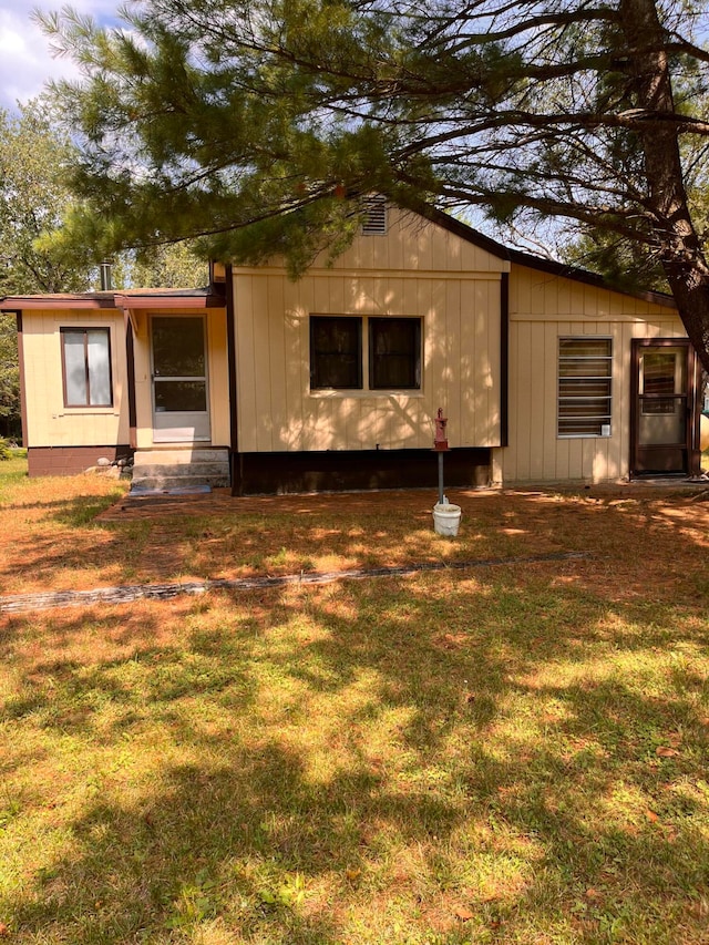 rear view of house with a lawn