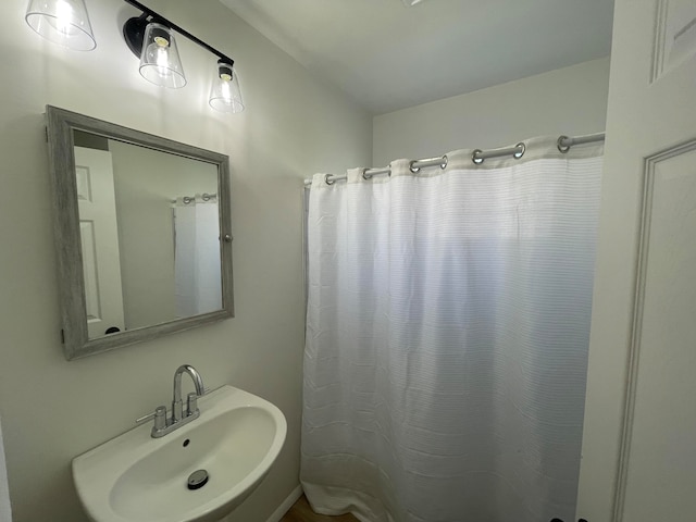 bathroom with sink and curtained shower