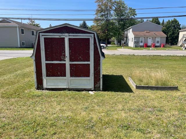 view of outdoor structure with a lawn