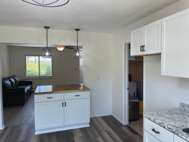 kitchen featuring dark hardwood / wood-style flooring, decorative light fixtures, white cabinetry, and ceiling fan