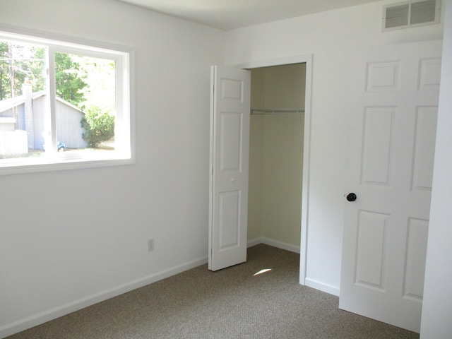 unfurnished bedroom featuring a closet and carpet floors