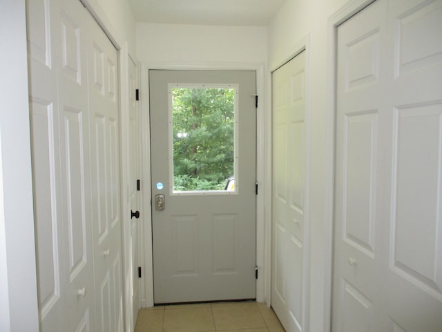 doorway featuring light tile patterned flooring