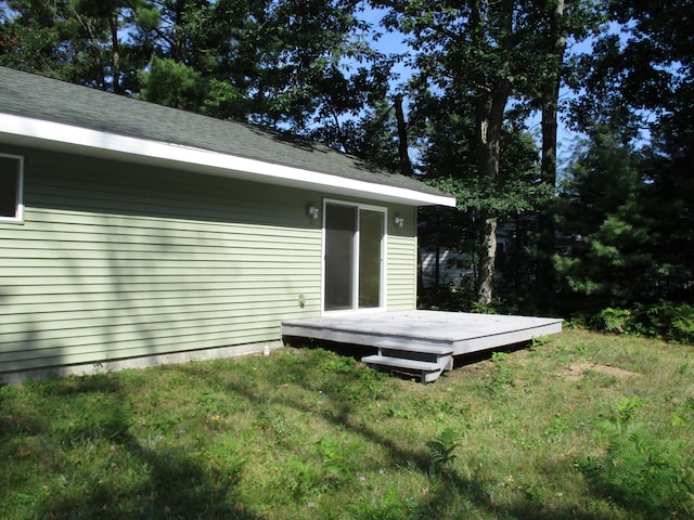 view of side of home featuring a yard and a deck