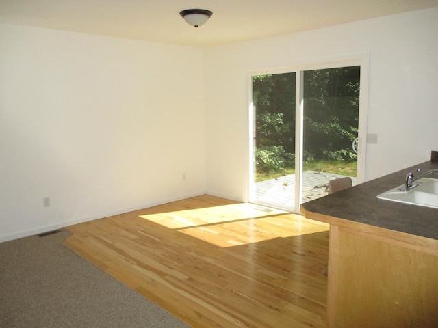 interior space with sink and light hardwood / wood-style floors