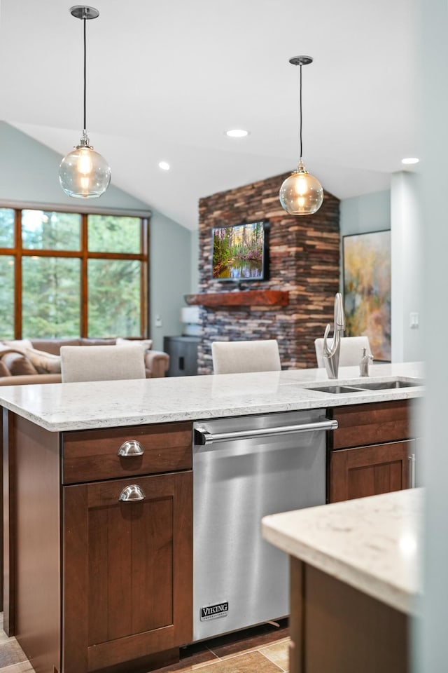 kitchen featuring dishwasher, lofted ceiling, sink, and decorative light fixtures