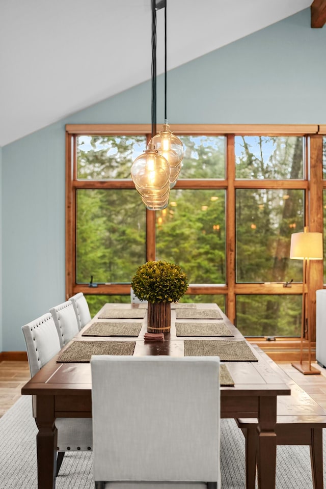 dining room featuring lofted ceiling and light wood-type flooring