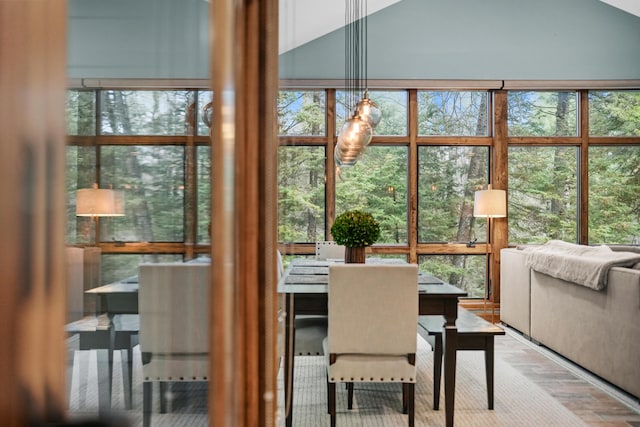 sunroom with lofted ceiling and a healthy amount of sunlight