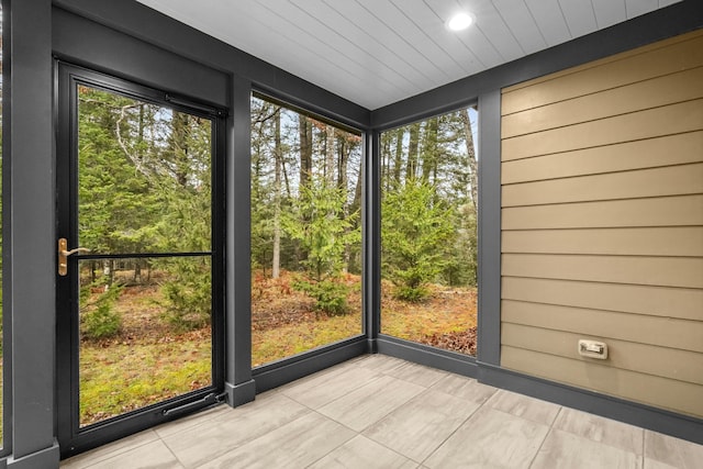 unfurnished sunroom featuring a wealth of natural light