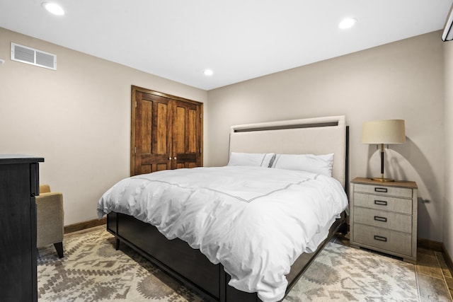 bedroom featuring hardwood / wood-style floors and a closet