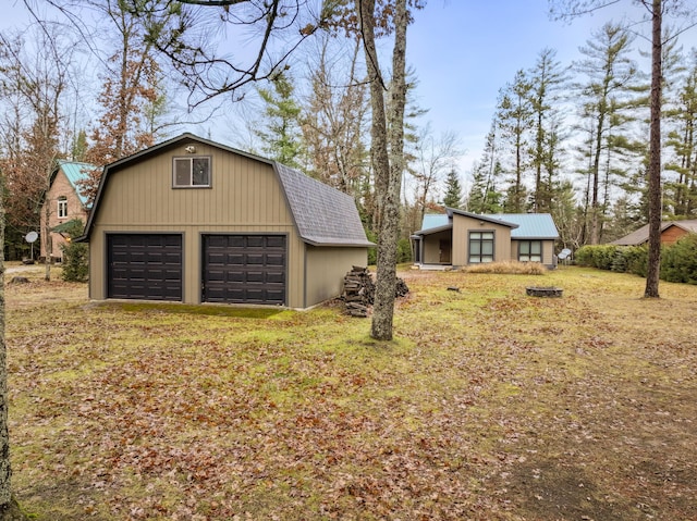 view of side of property with a garage and an outdoor structure