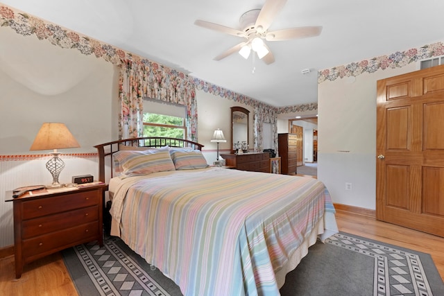 bedroom with ceiling fan and light hardwood / wood-style floors