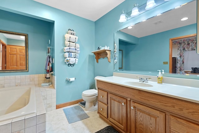 bathroom featuring tiled bath, toilet, vanity, and tile patterned floors