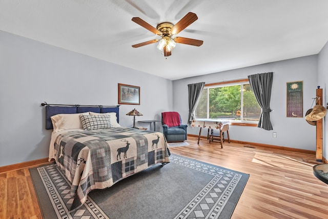 bedroom with ceiling fan and light hardwood / wood-style flooring