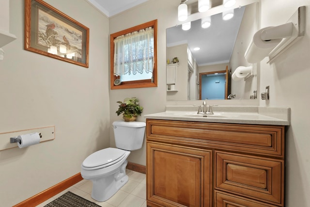 bathroom with tile patterned flooring, toilet, ornamental molding, and vanity