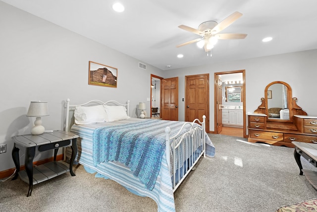 bedroom with carpet floors, ceiling fan, and ensuite bathroom