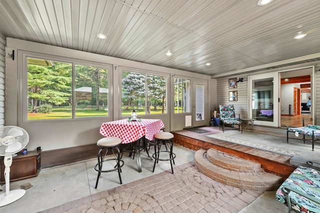 sunroom / solarium featuring wood ceiling