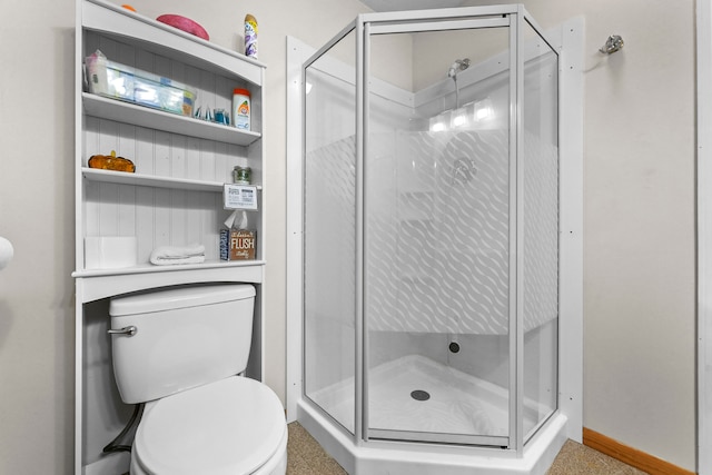 bathroom with a shower with door and toilet