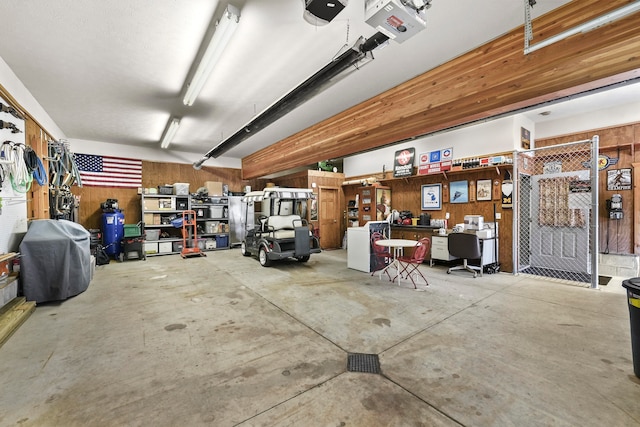 garage with a workshop area and a garage door opener