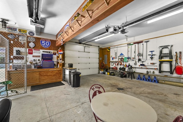 garage with a garage door opener and a workshop area