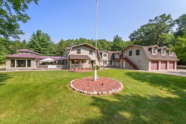 exterior space with a garage and a lawn