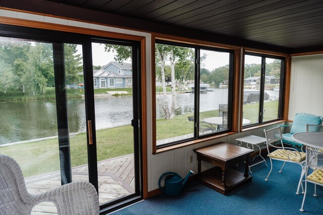 sunroom with a water view and a healthy amount of sunlight