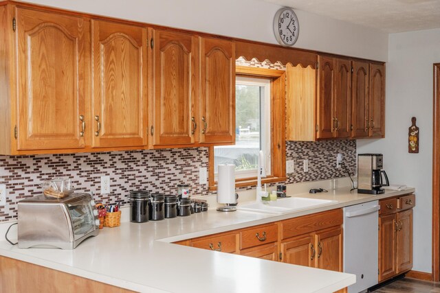 kitchen featuring sink, decorative backsplash, and dishwasher