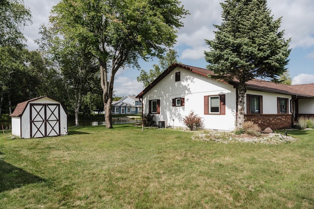 exterior space featuring a storage shed and a lawn