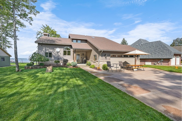 view of front of property with a front yard and a garage