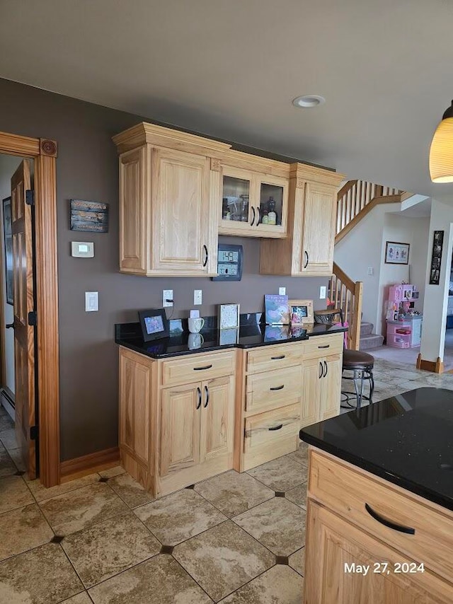 kitchen with light brown cabinets and light tile patterned floors