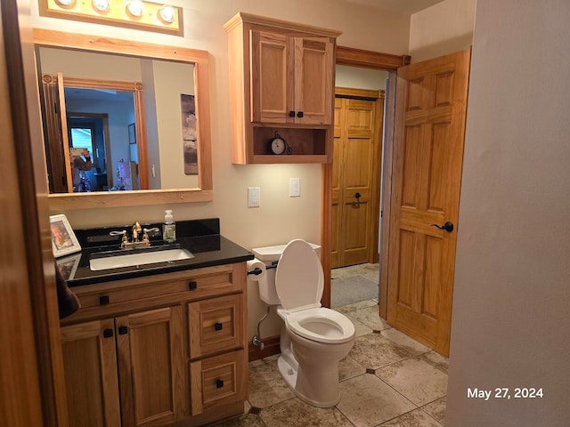 bathroom featuring toilet, vanity, and tile patterned floors