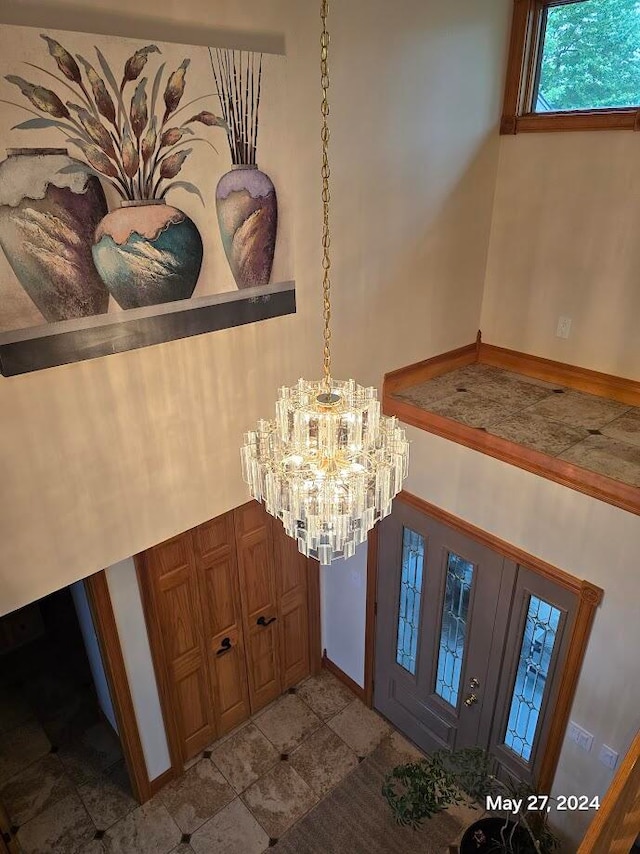 interior space with tile patterned floors and a notable chandelier