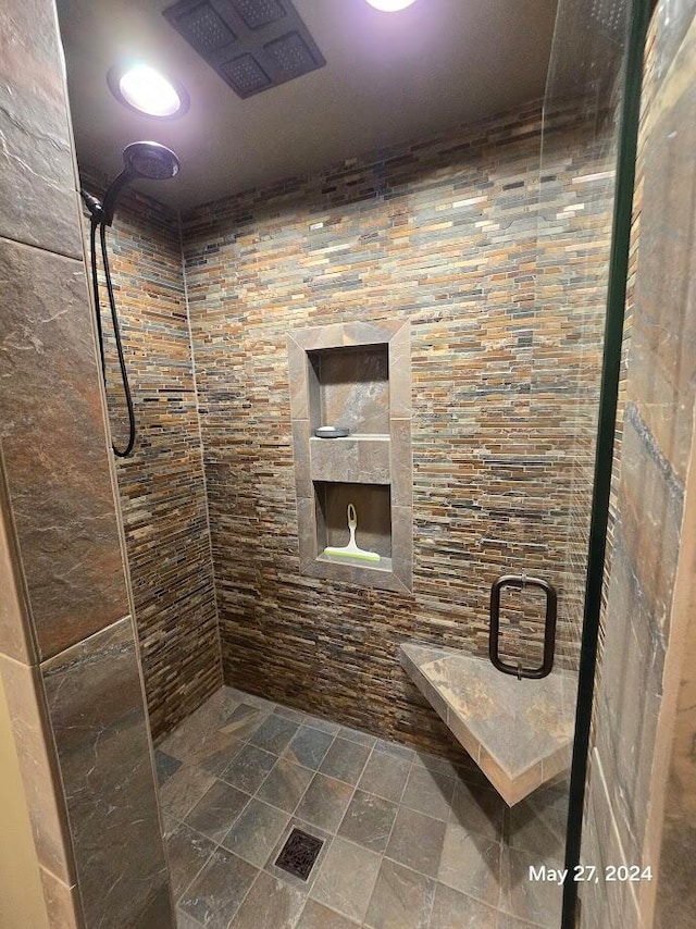 bathroom featuring a shower with door