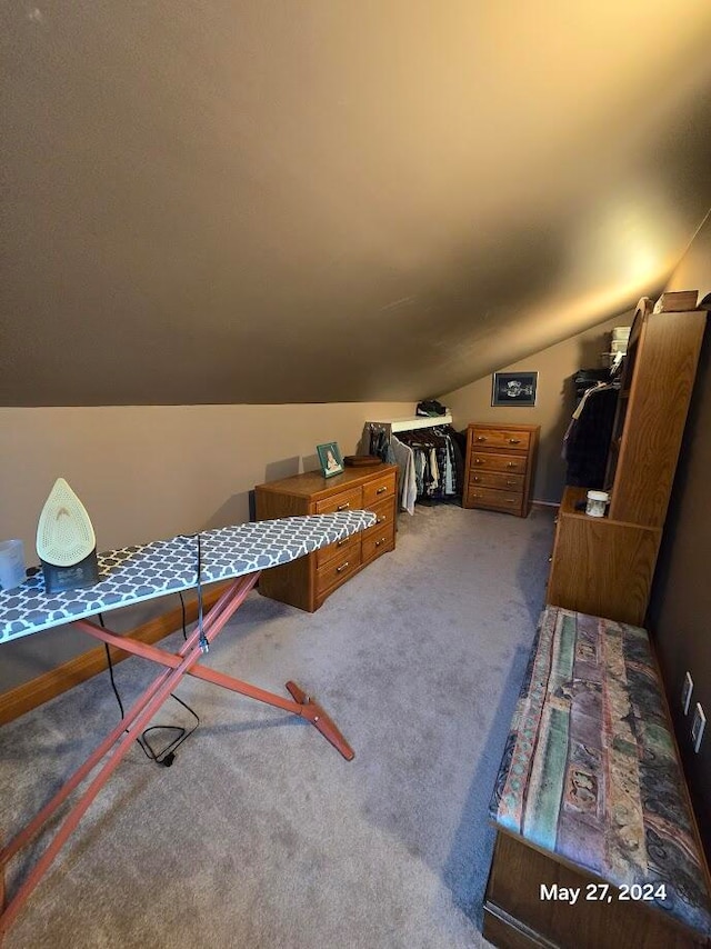 carpeted bedroom featuring vaulted ceiling