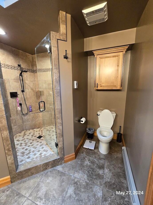 bathroom featuring a baseboard heating unit, toilet, walk in shower, and tile patterned floors