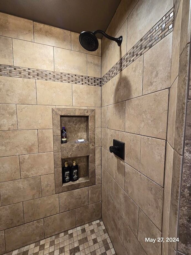 bathroom with a tile shower