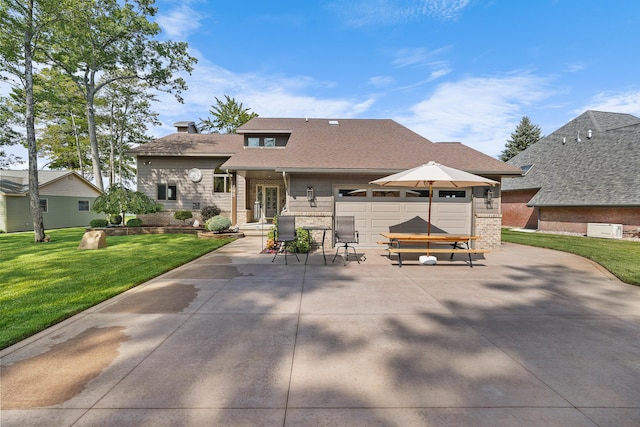 view of front of house with a front yard and a garage