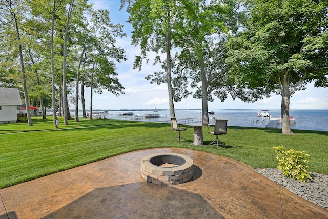 view of patio / terrace with a water view and a fire pit