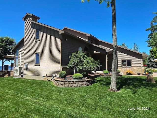 view of side of home with a lawn