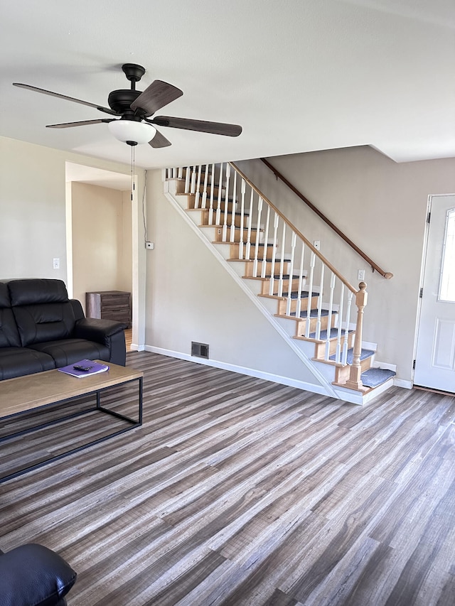 living room featuring ceiling fan and wood-type flooring