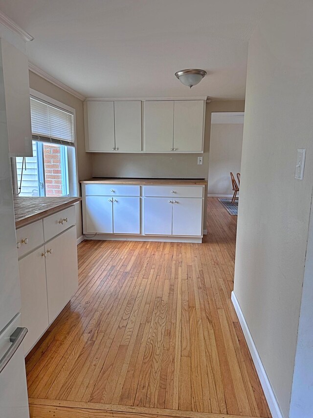 kitchen featuring white cabinets and light wood-type flooring