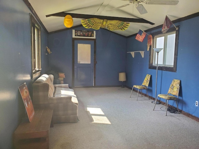 sitting room with ceiling fan, carpet flooring, and vaulted ceiling